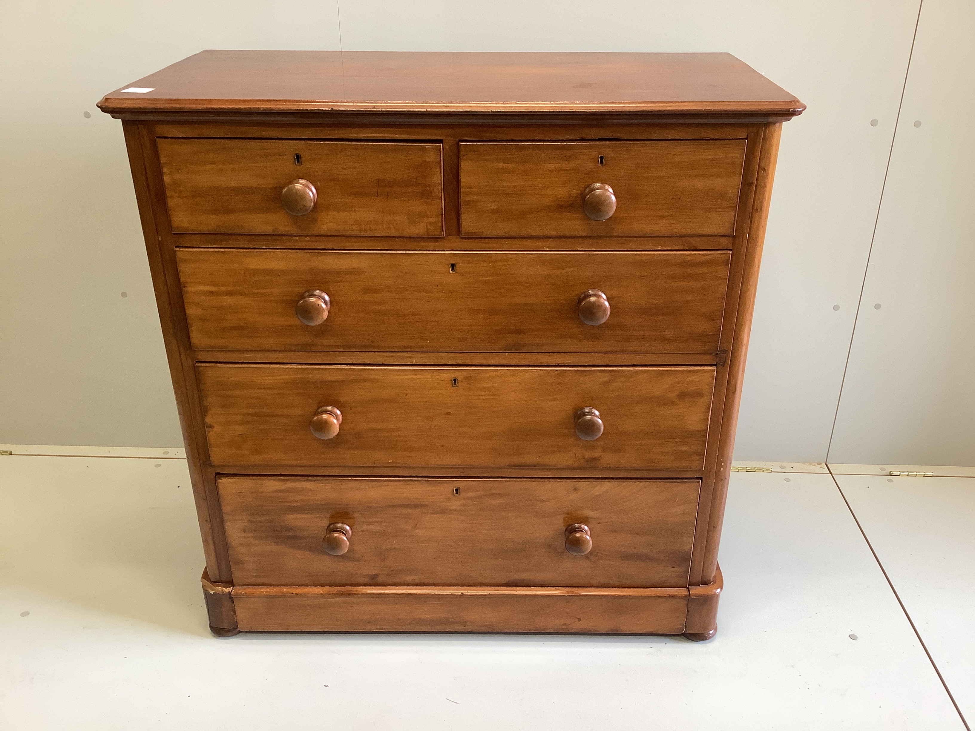 A Victorian mahogany chest of two short and three long drawers, fitted with turned mahogany handles, width 106cm, depth 51cm, height 106cm